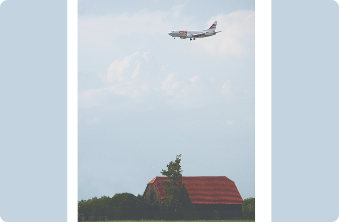 air plane flying over house