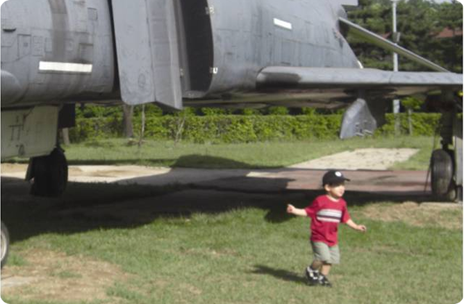 boy running under plane