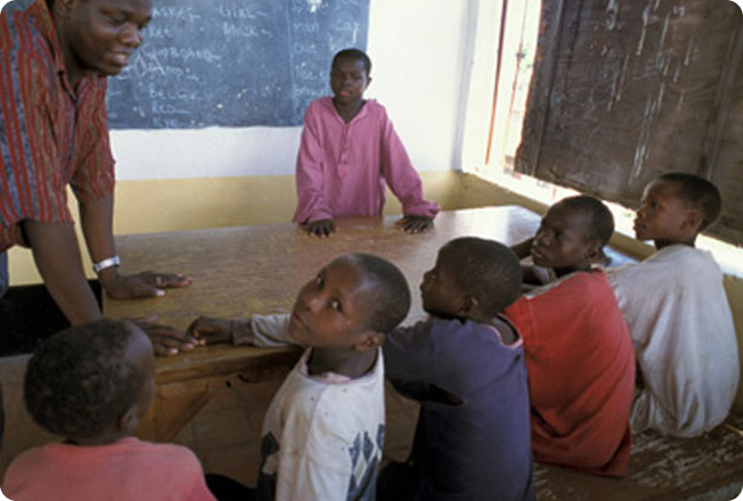 five boys sitting in a room
