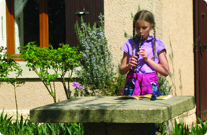 girl playing in front of house.