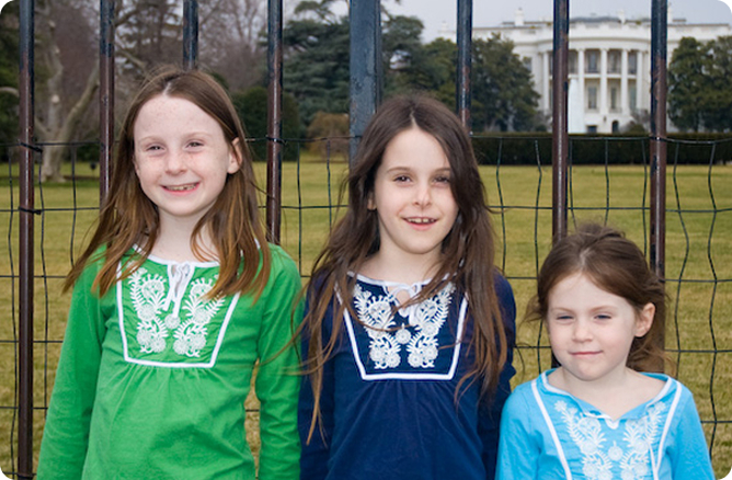girls three standing in front of a house 2