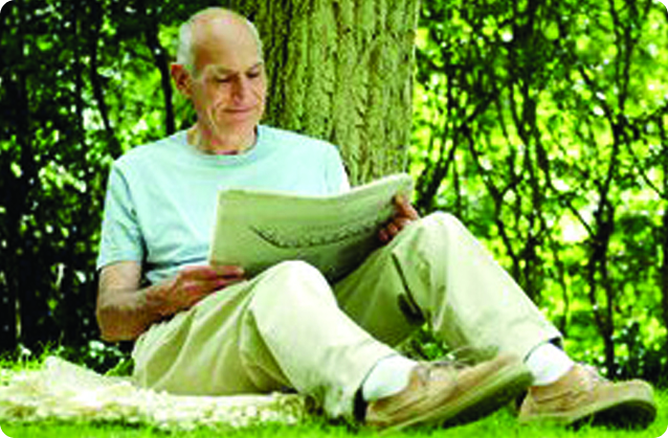 man reading under tree