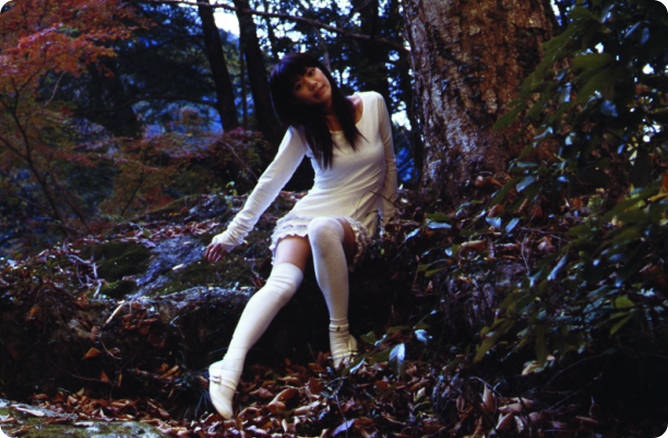 woman sitting beside a tree