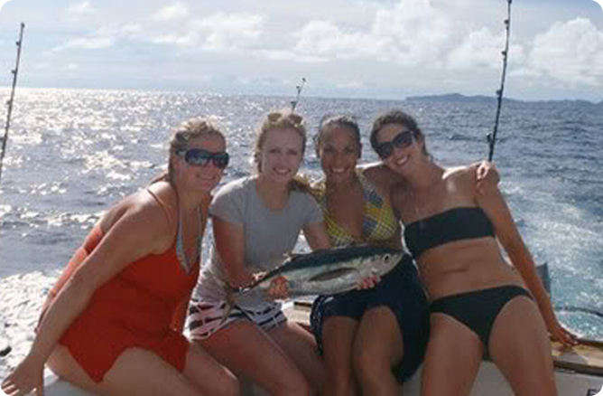 women sitting behind fish